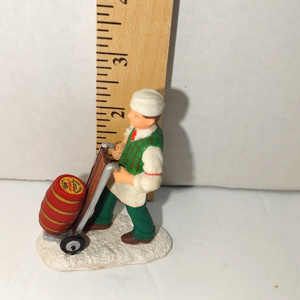 A ceramic Coca-Cola figurine